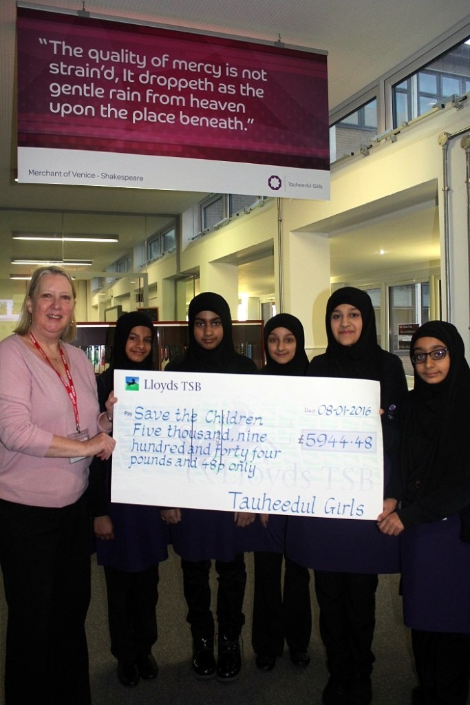 Pupils at Tauheedul Islam Girls’ High School and Sixth Form College presenting Frances Seth with a cheque for Save the Children's Refugee Appeal
